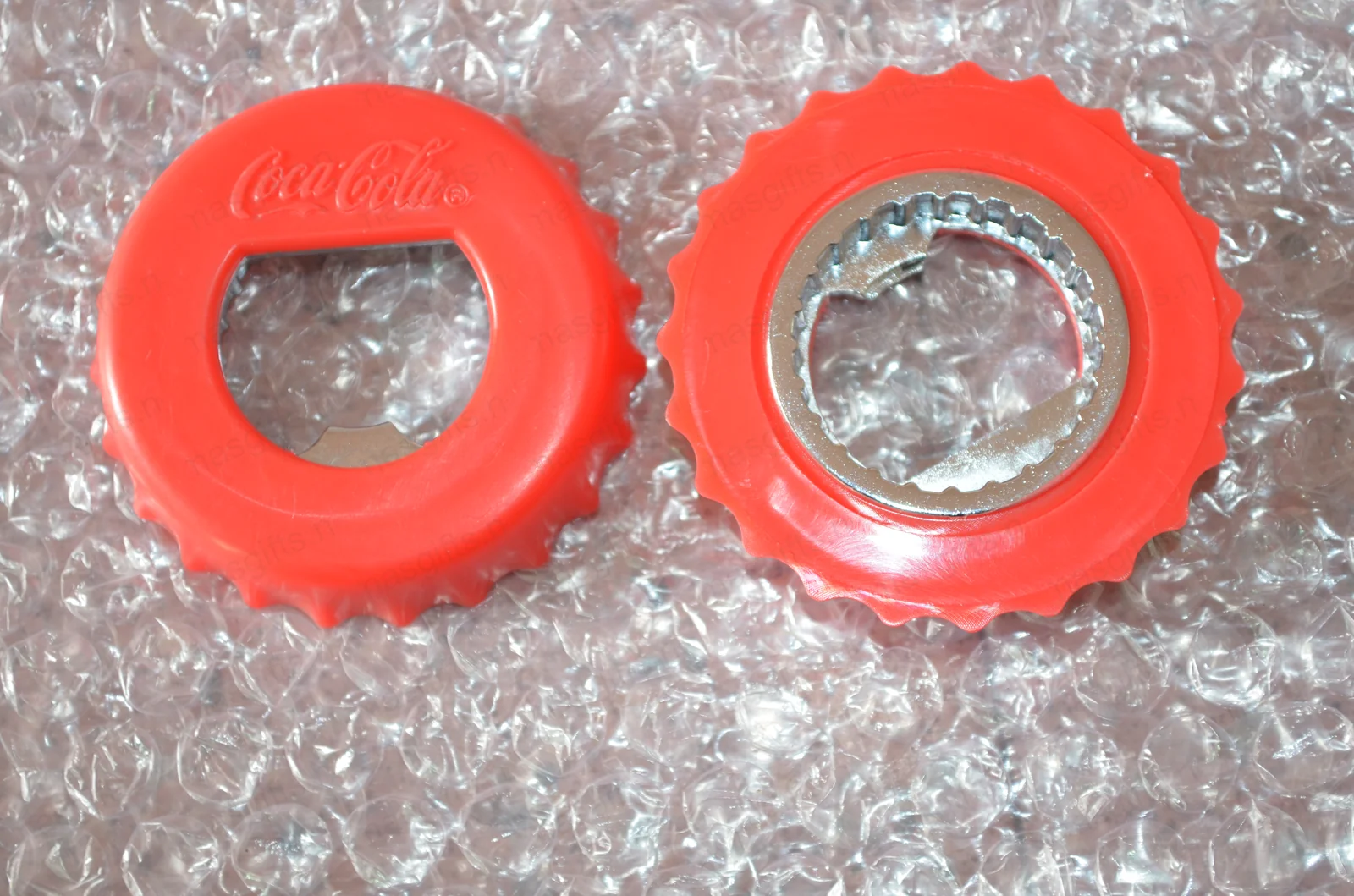 Pair of Coca-Cola silicone two-function bottle openers — real product sample from the 2012 Czech order