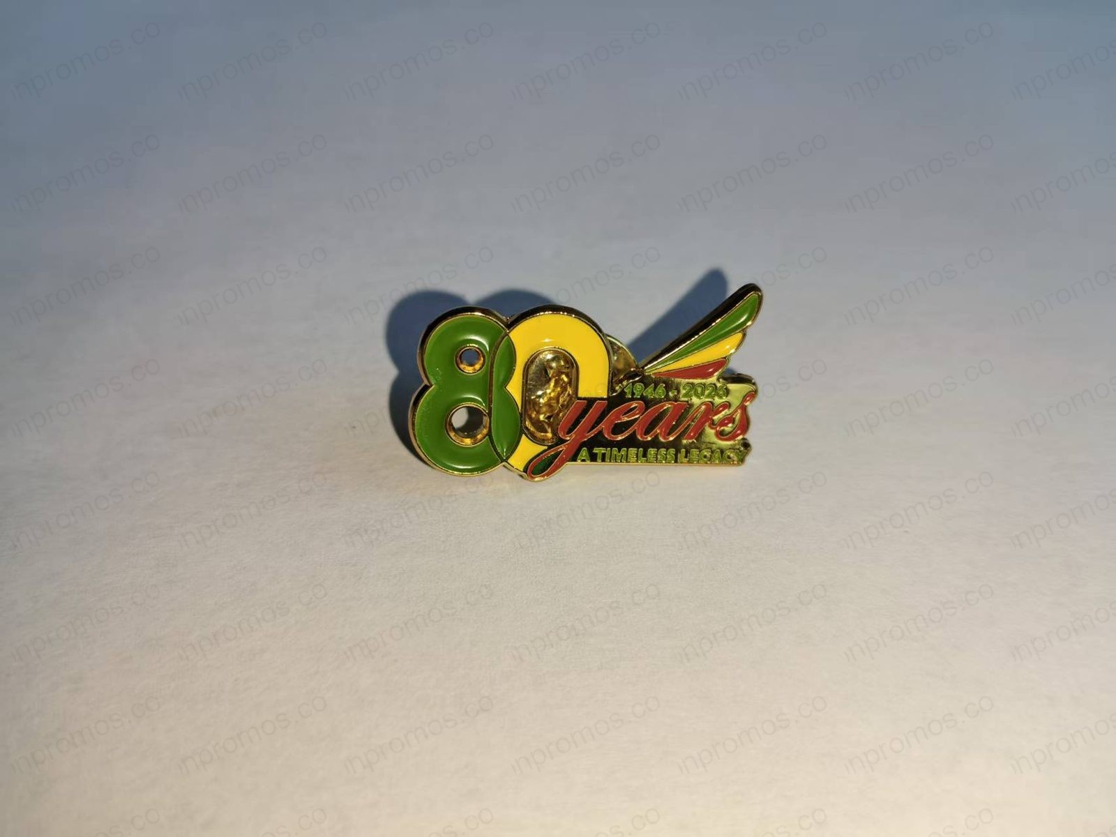 Enamel pin with 80 years in Ethiopian flag colors — production photo