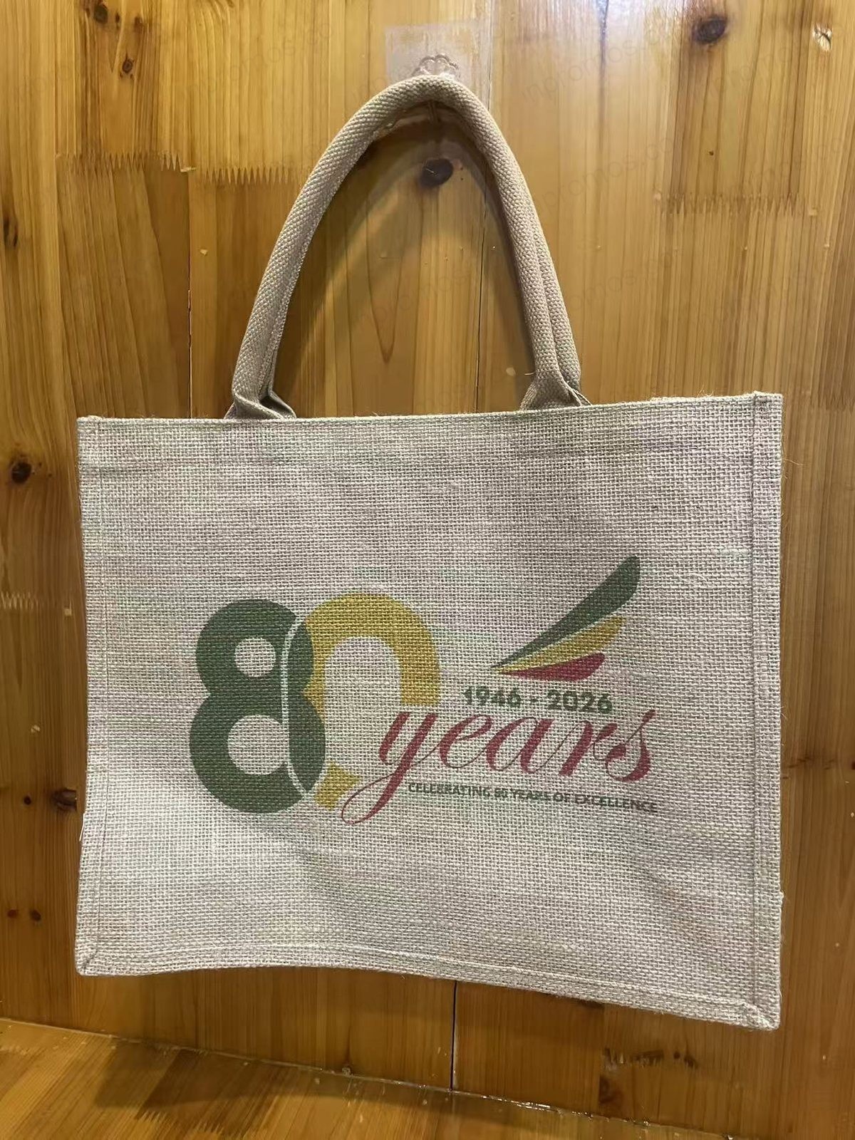 Jute tote bag on wooden surface — production photo