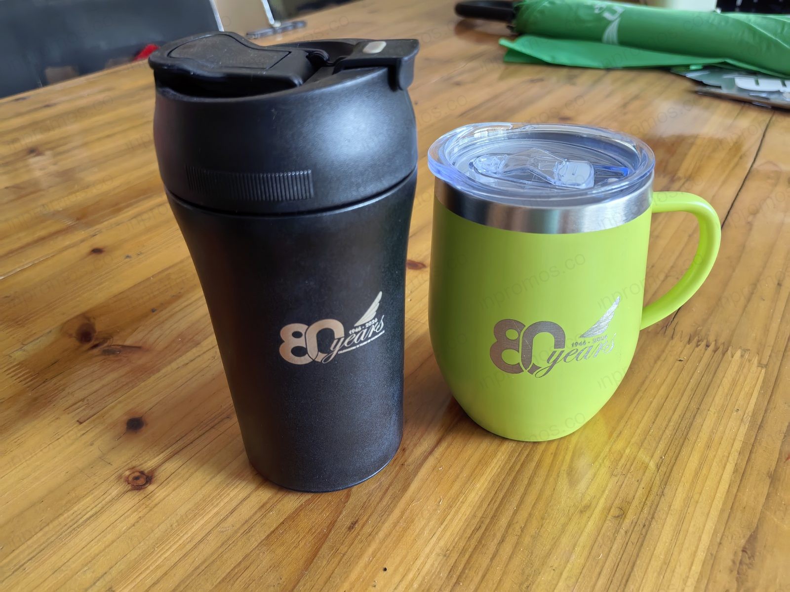 Black and green ceramic mugs with 80 years logo — production photo