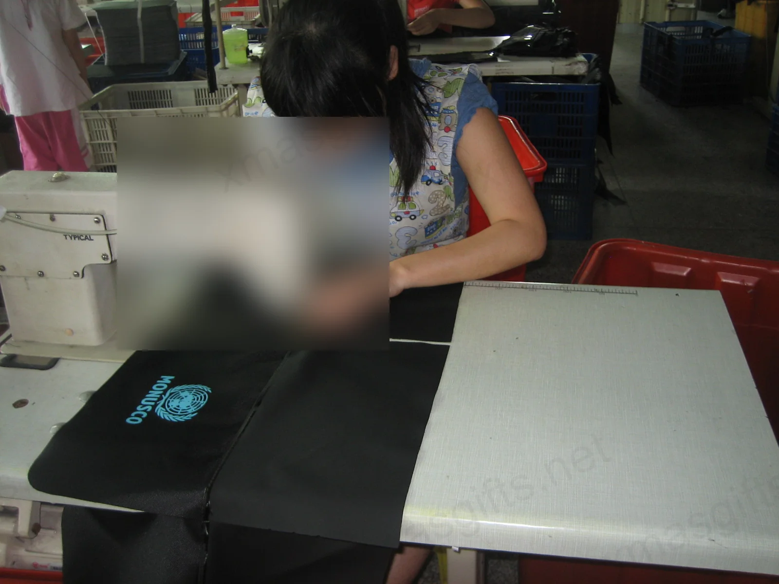 Operator sewing MONUSCO branded bag